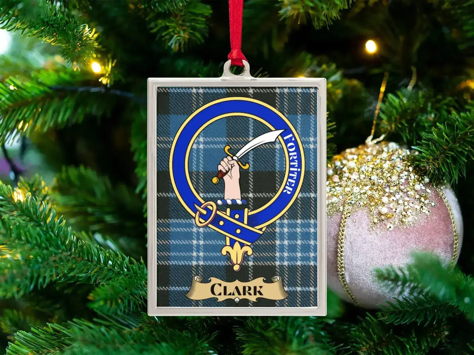 Clark clan crest Christmas ornament in a silver frame on a tartan background