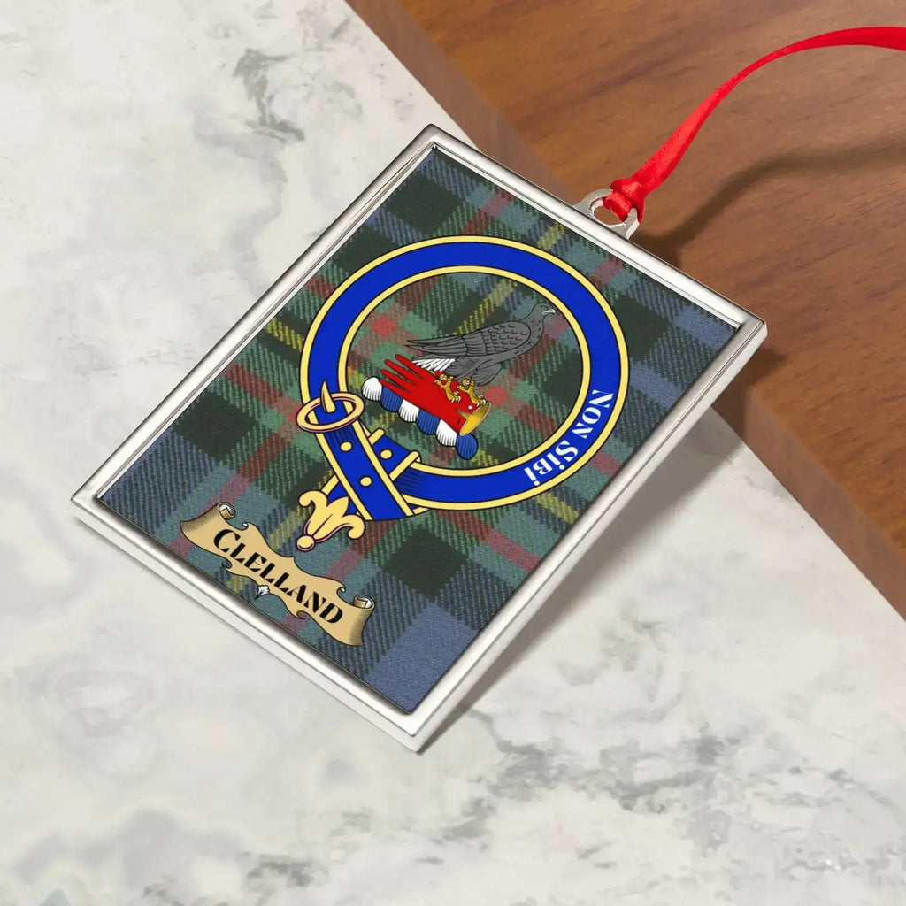 Clelland ornament hanging from a Christmas tree branch by its satin ribbon