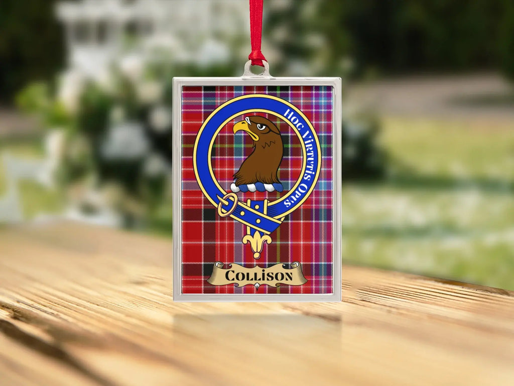 Close-up of the Collison family crest on a polished silver-frame metal ornament