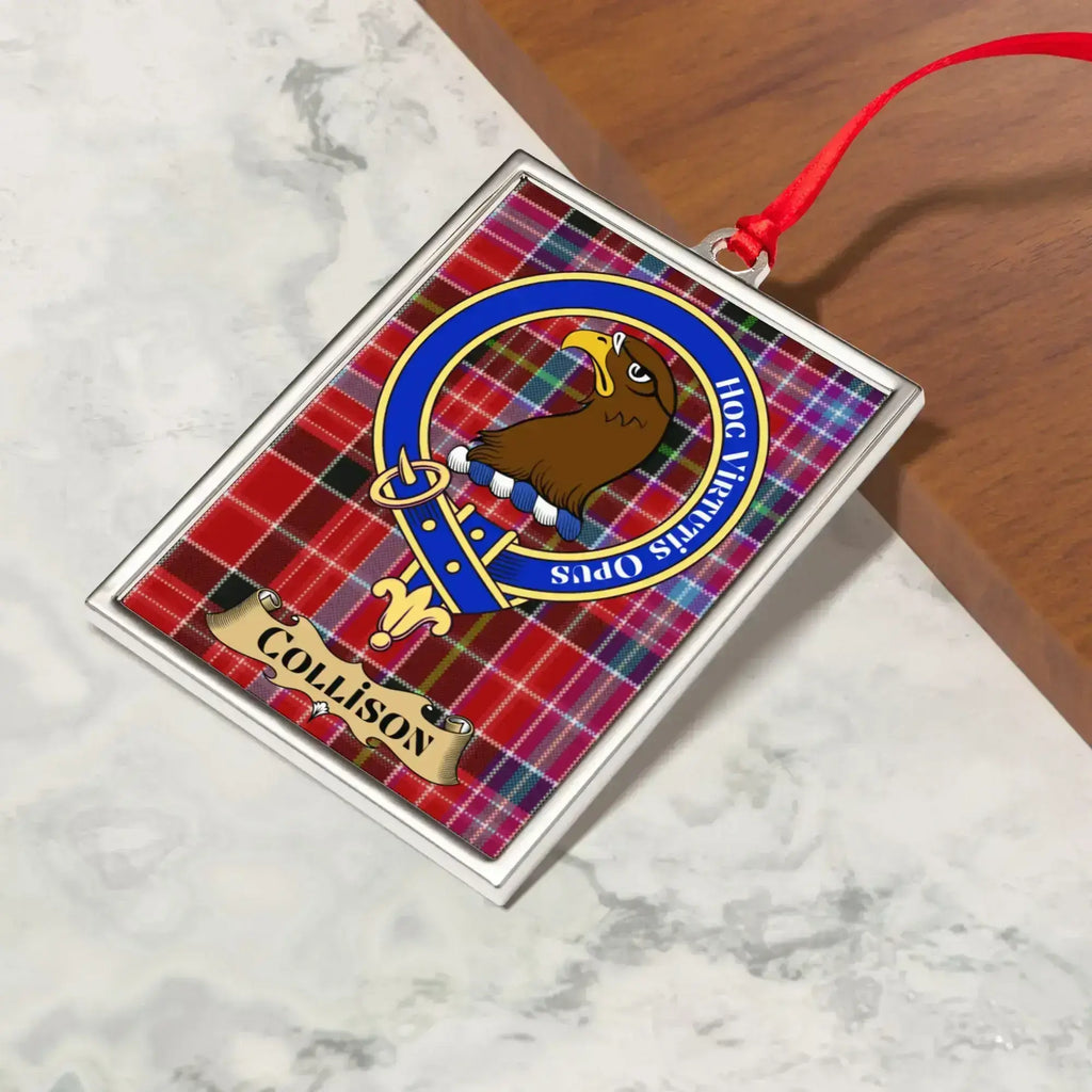 Collison ornament hanging from a Christmas tree branch by its satin ribbon