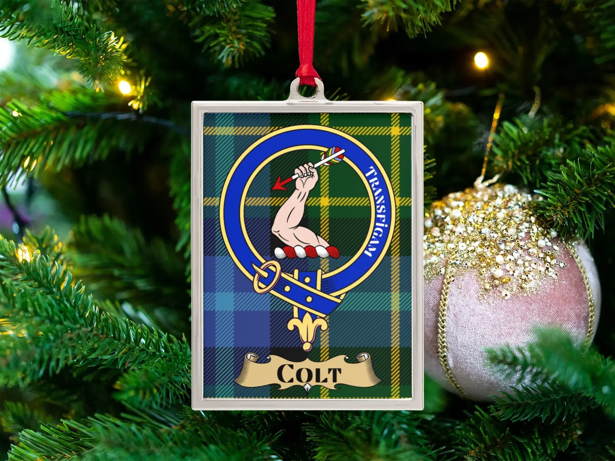 Colt clan crest Christmas ornament in a silver frame on a tartan background