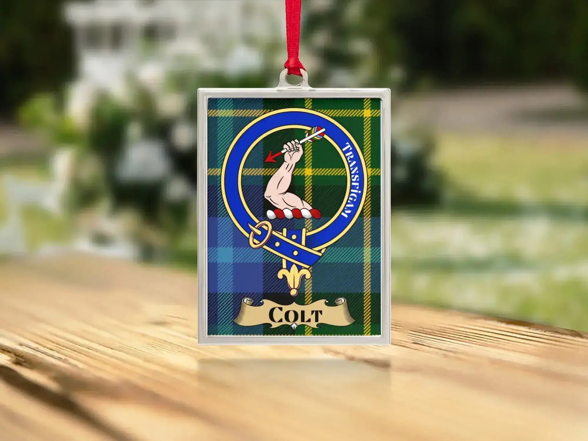 Close-up of the Colt family crest on a polished silver-frame metal ornament