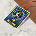 Colt ornament hanging from a Christmas tree branch by its satin ribbon