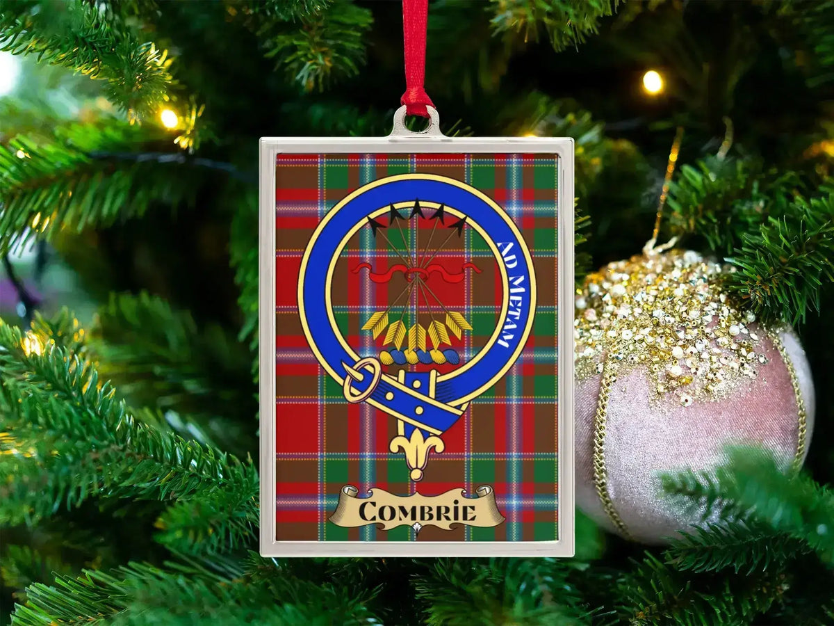 Combrie clan crest Christmas ornament in a silver frame on a tartan background