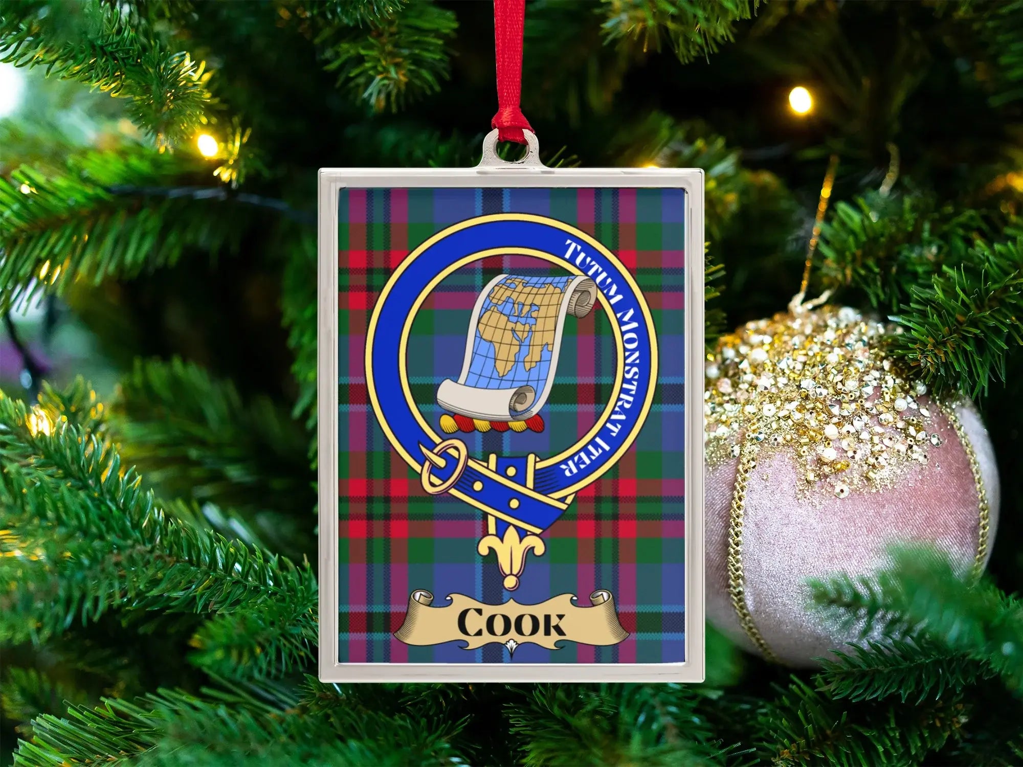 Cook clan crest Christmas ornament in a silver frame on a tartan background