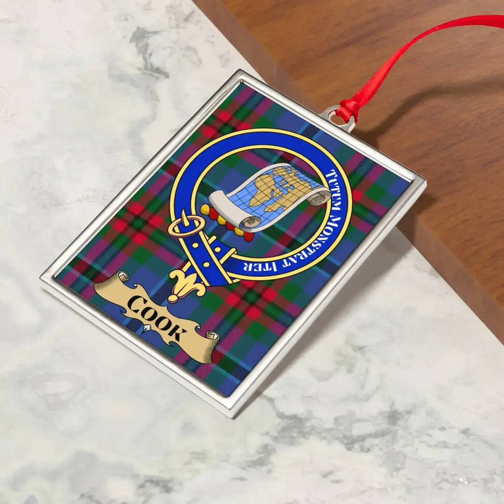 Cook ornament hanging from a Christmas tree branch by its satin ribbon