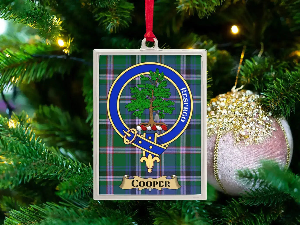 Cooper clan crest Christmas ornament in a silver frame on a tartan background