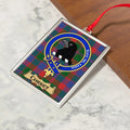 Corbet ornament hanging from a Christmas tree branch by its satin ribbon
