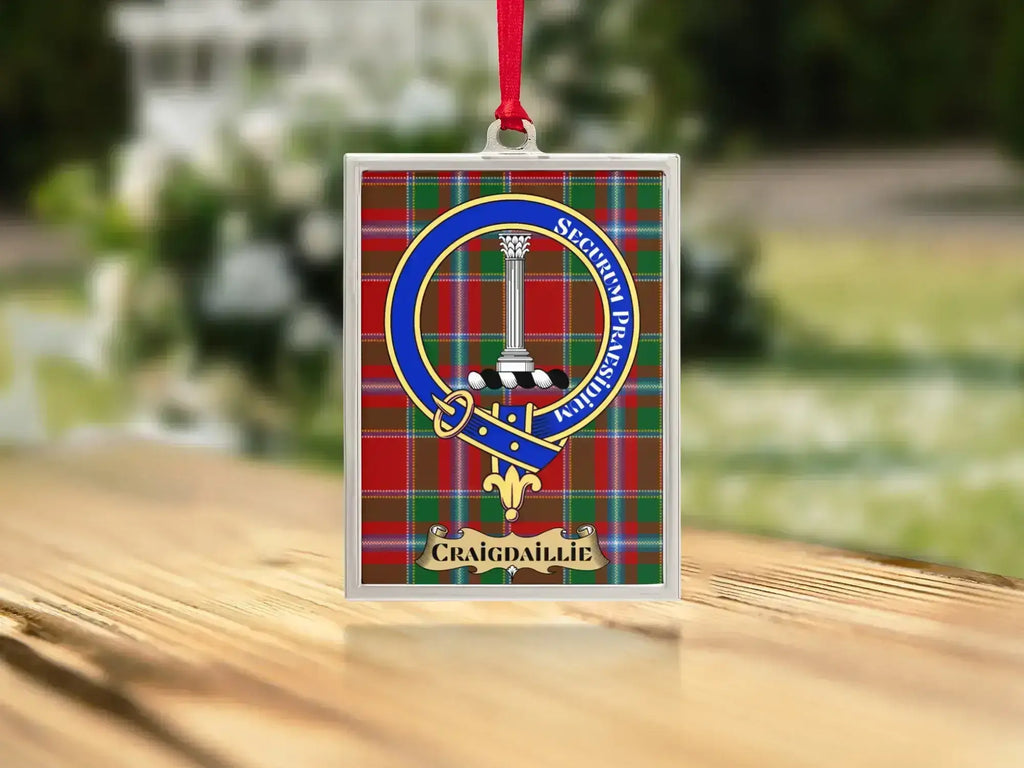 Close-up of the Craigdaillie family crest on a polished silver-frame metal ornament