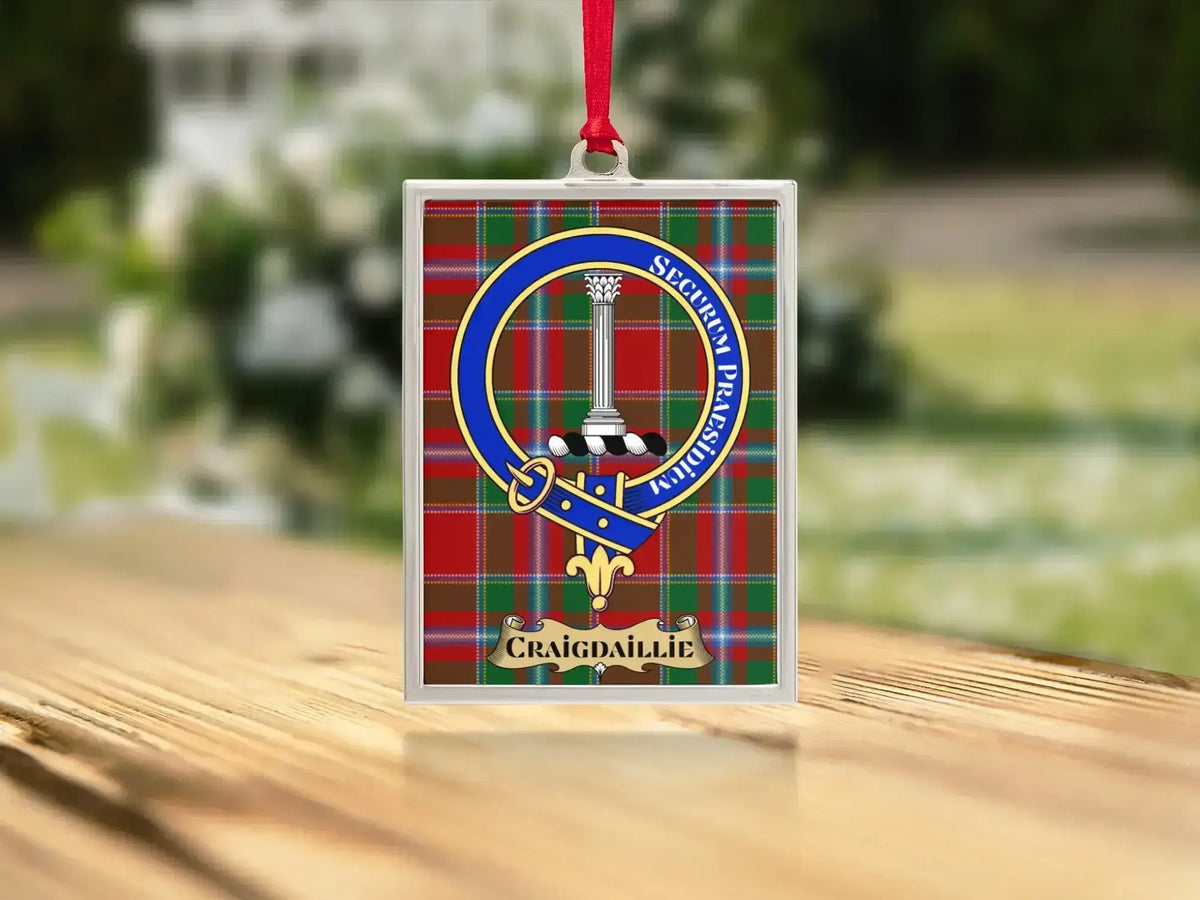 Close-up of the Craigdaillie family crest on a polished silver-frame metal ornament