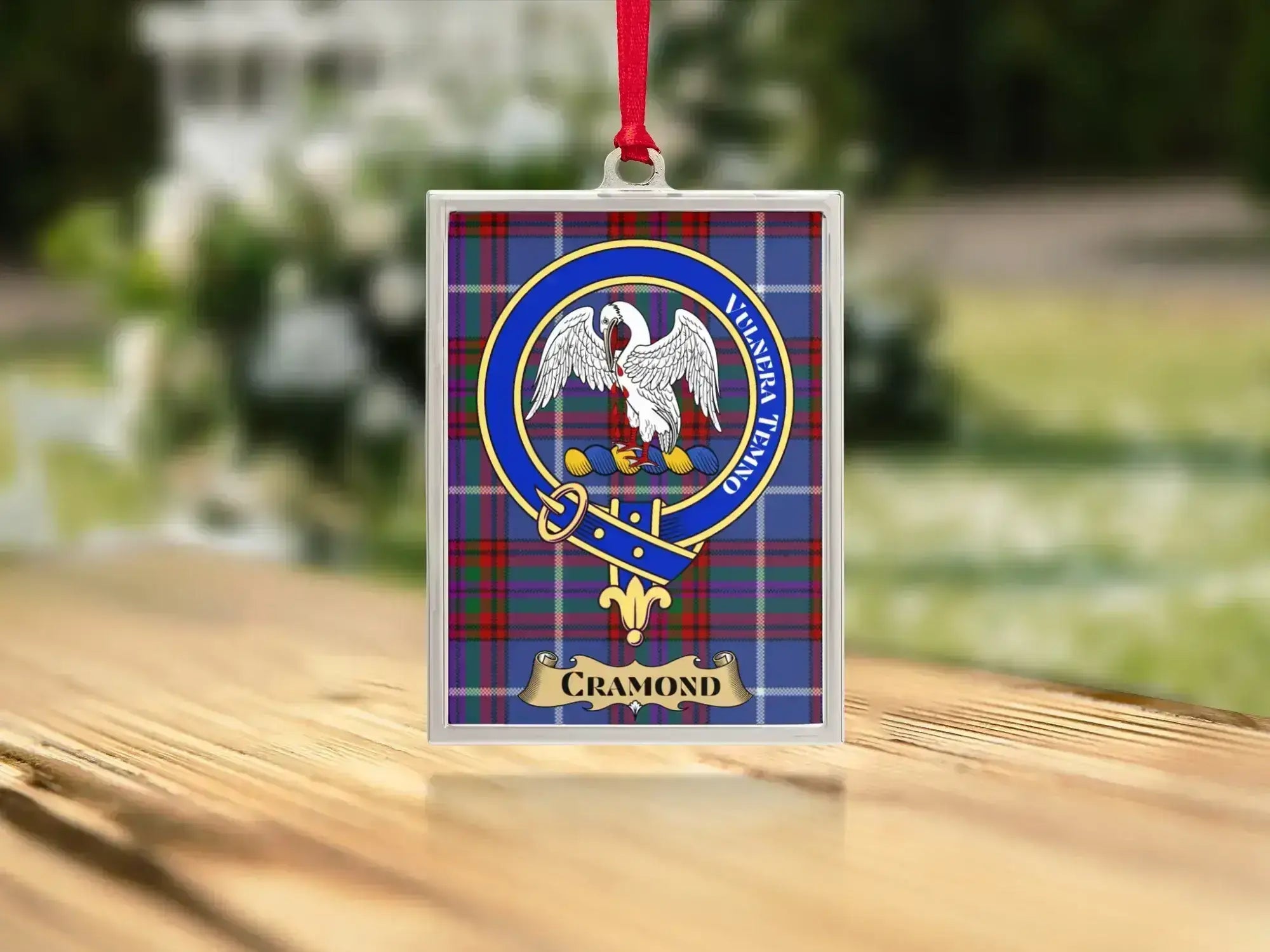 Close-up of the Cramond family crest on a polished silver-frame metal ornament