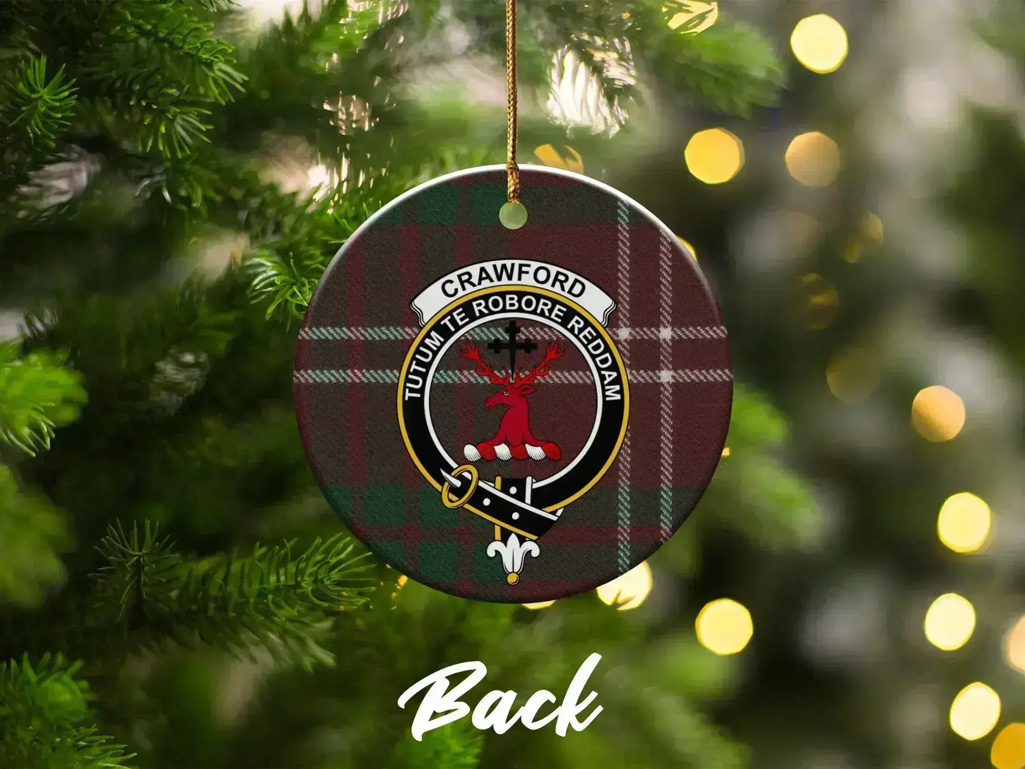 Crawford tartan crest ornament on Christmas tree — stag heraldic design with Strength motto visible