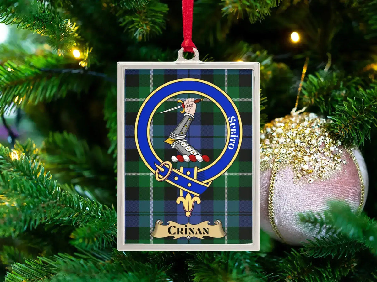 Crinan clan crest Christmas ornament in a silver frame on a tartan background