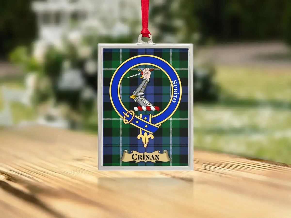 Close-up of the Crinan family crest on a polished silver-frame metal ornament