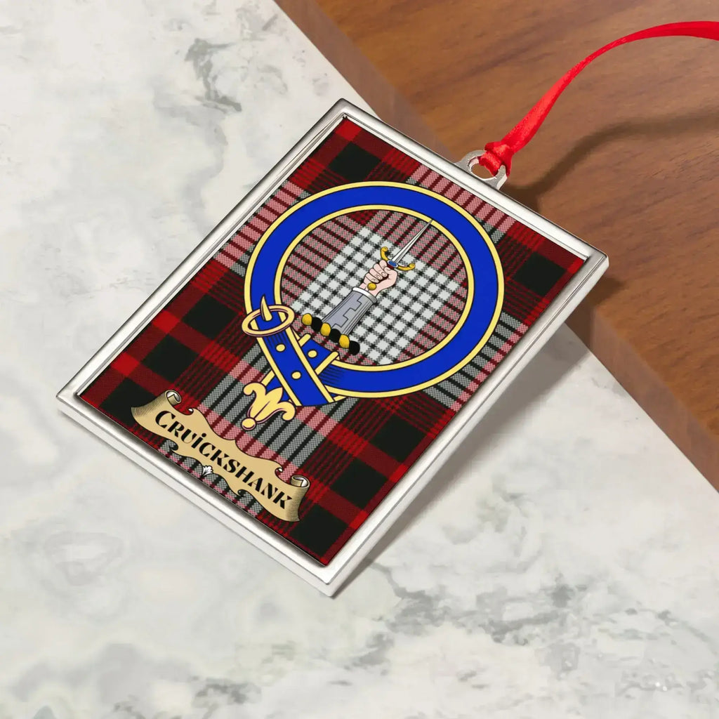 Cruickshank ornament hanging from a Christmas tree branch by its satin ribbon