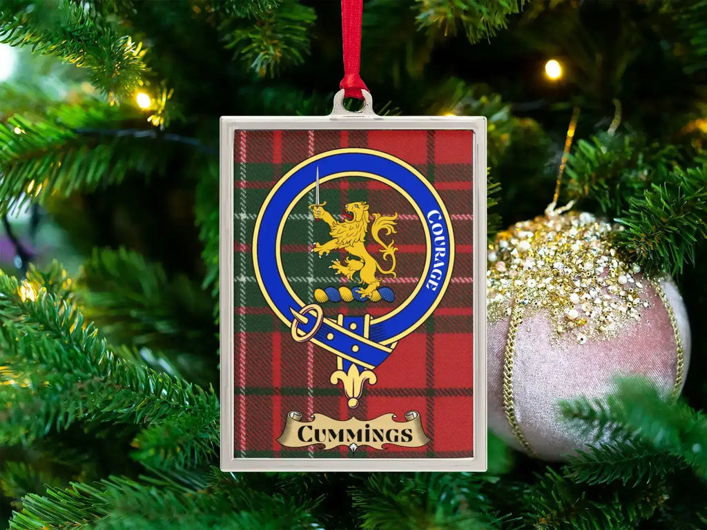 Cummings clan crest Christmas ornament in a silver frame on a tartan background