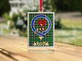 Close-up of the Curry family crest on a polished silver-frame metal ornament