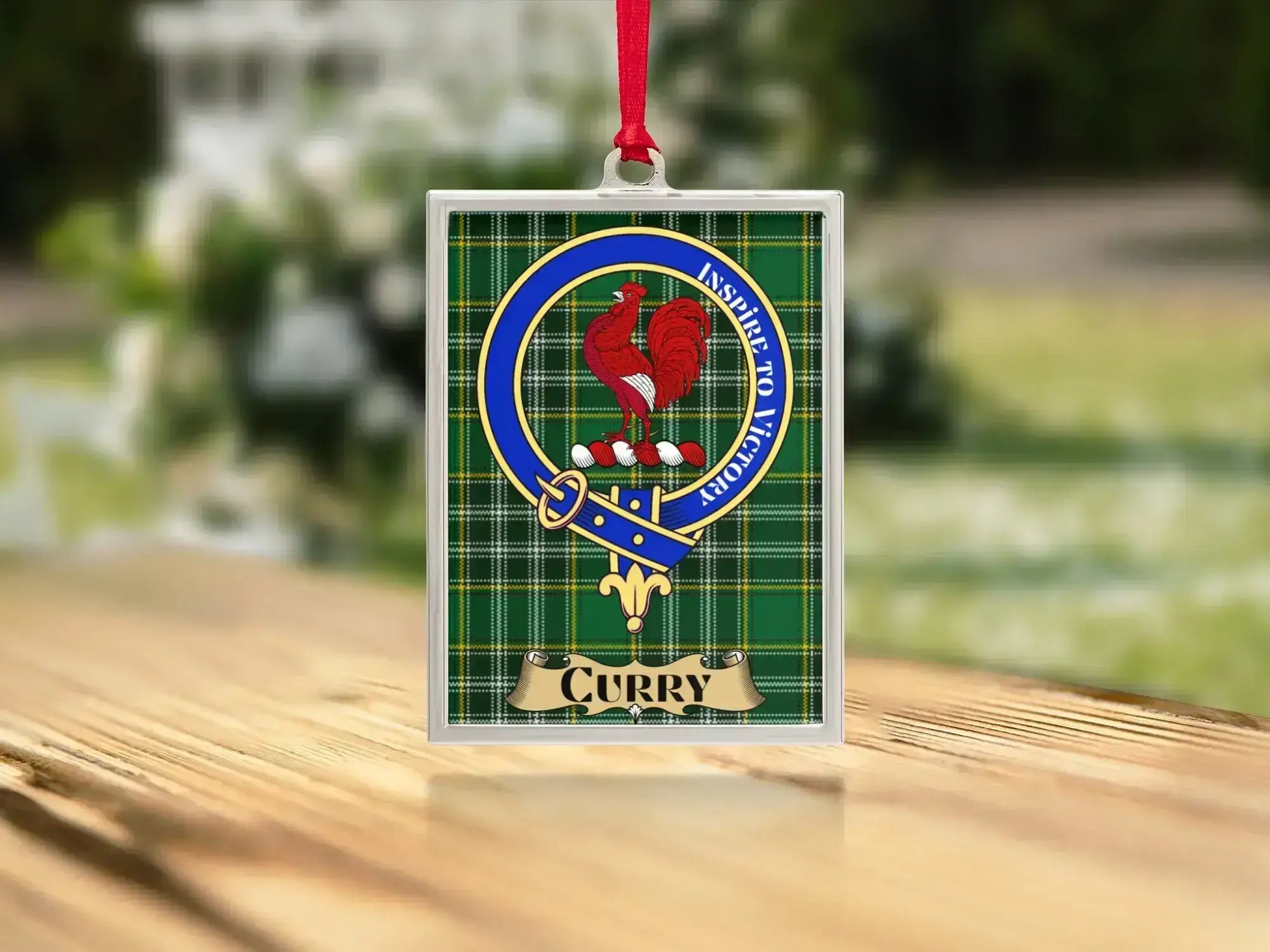 Close-up of the Curry family crest on a polished silver-frame metal ornament
