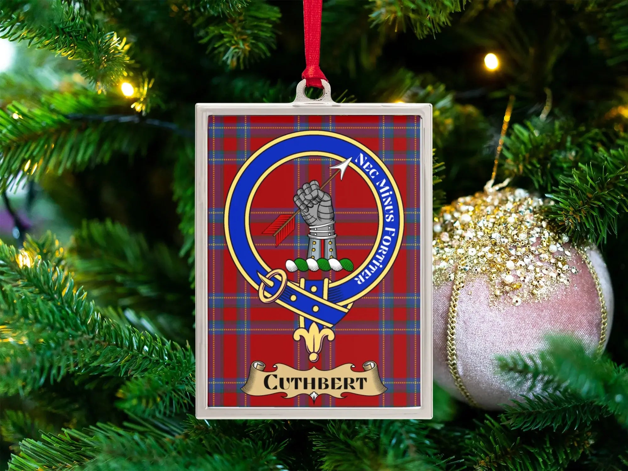 Cuthbert clan crest Christmas ornament in a silver frame on a tartan background