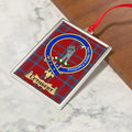 Cuthbert ornament hanging from a Christmas tree branch by its satin ribbon
