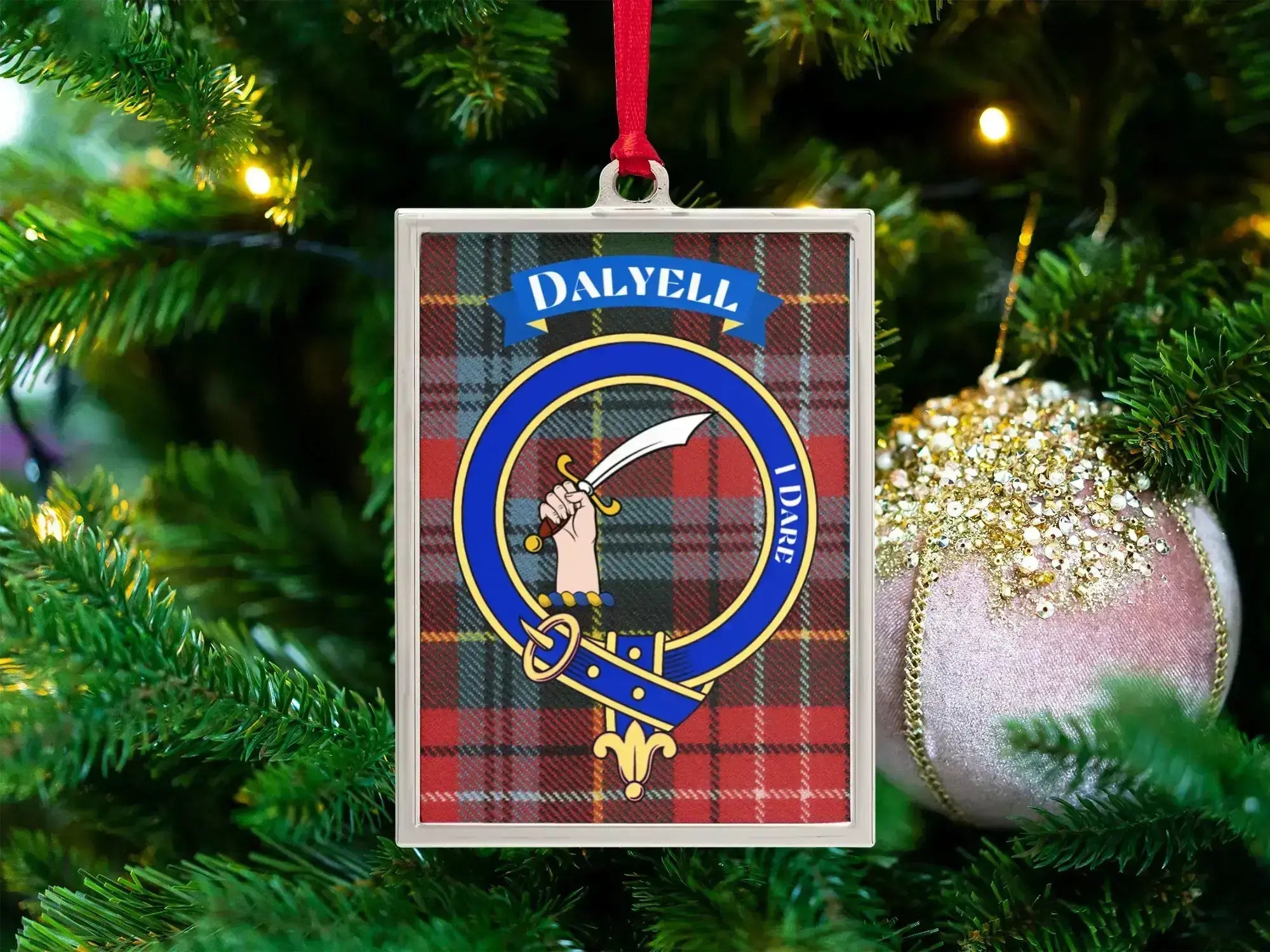 Dalyell clan crest Christmas ornament in a silver frame on a tartan background