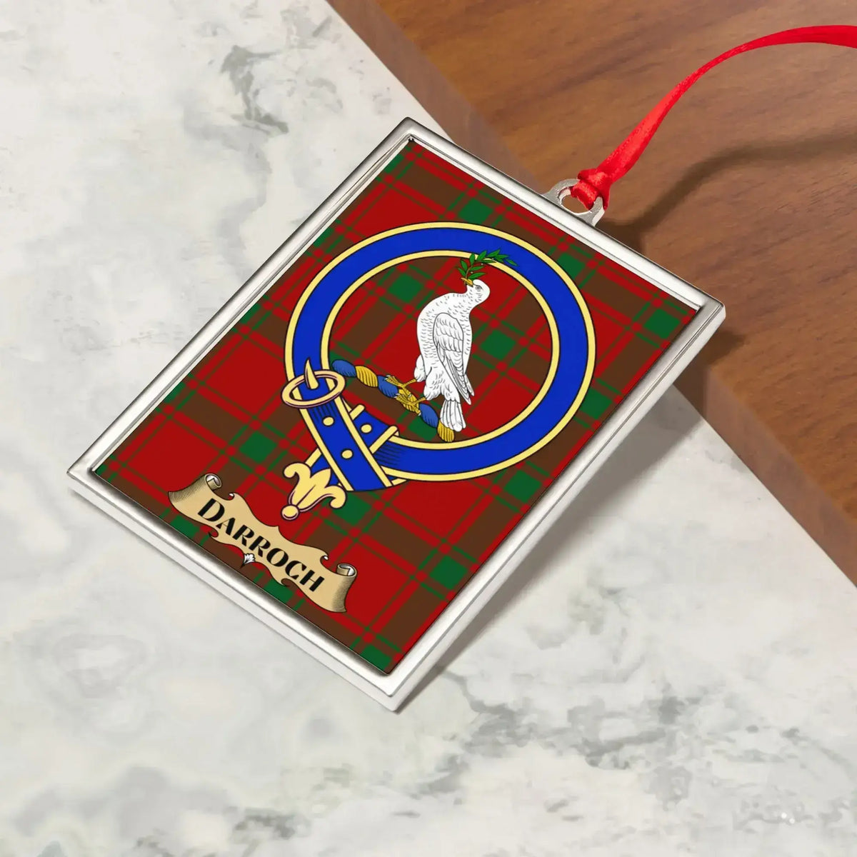 Darroch ornament hanging from a Christmas tree branch by its satin ribbon
