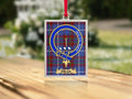 Close-up of the Deas family crest on a polished silver-frame metal ornament