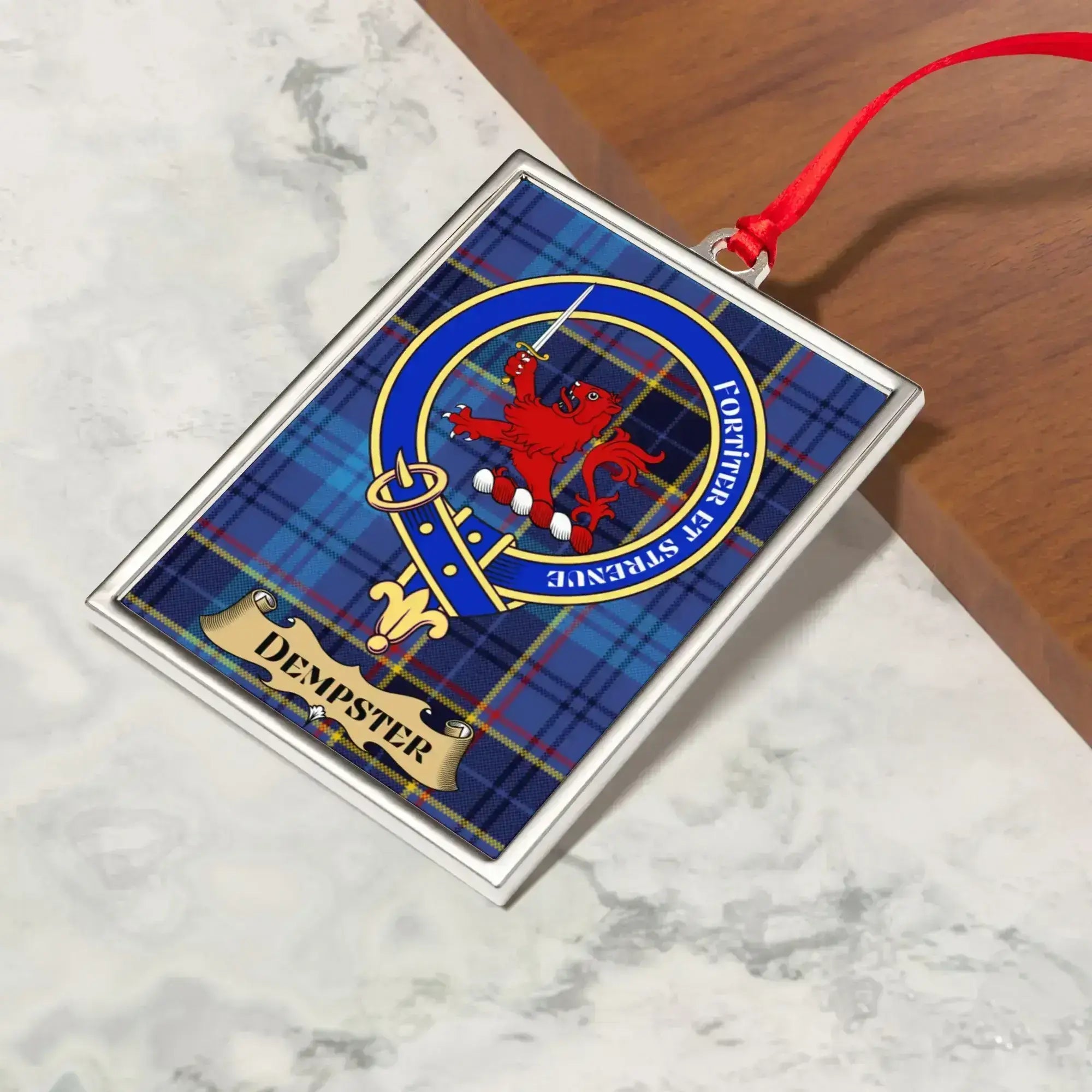 Dempster ornament hanging from a Christmas tree branch by its satin ribbon