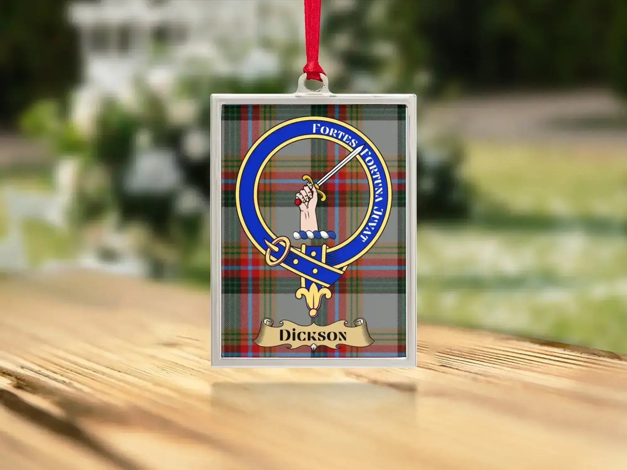Close-up of the Dickson family crest on a polished silver-frame metal ornament