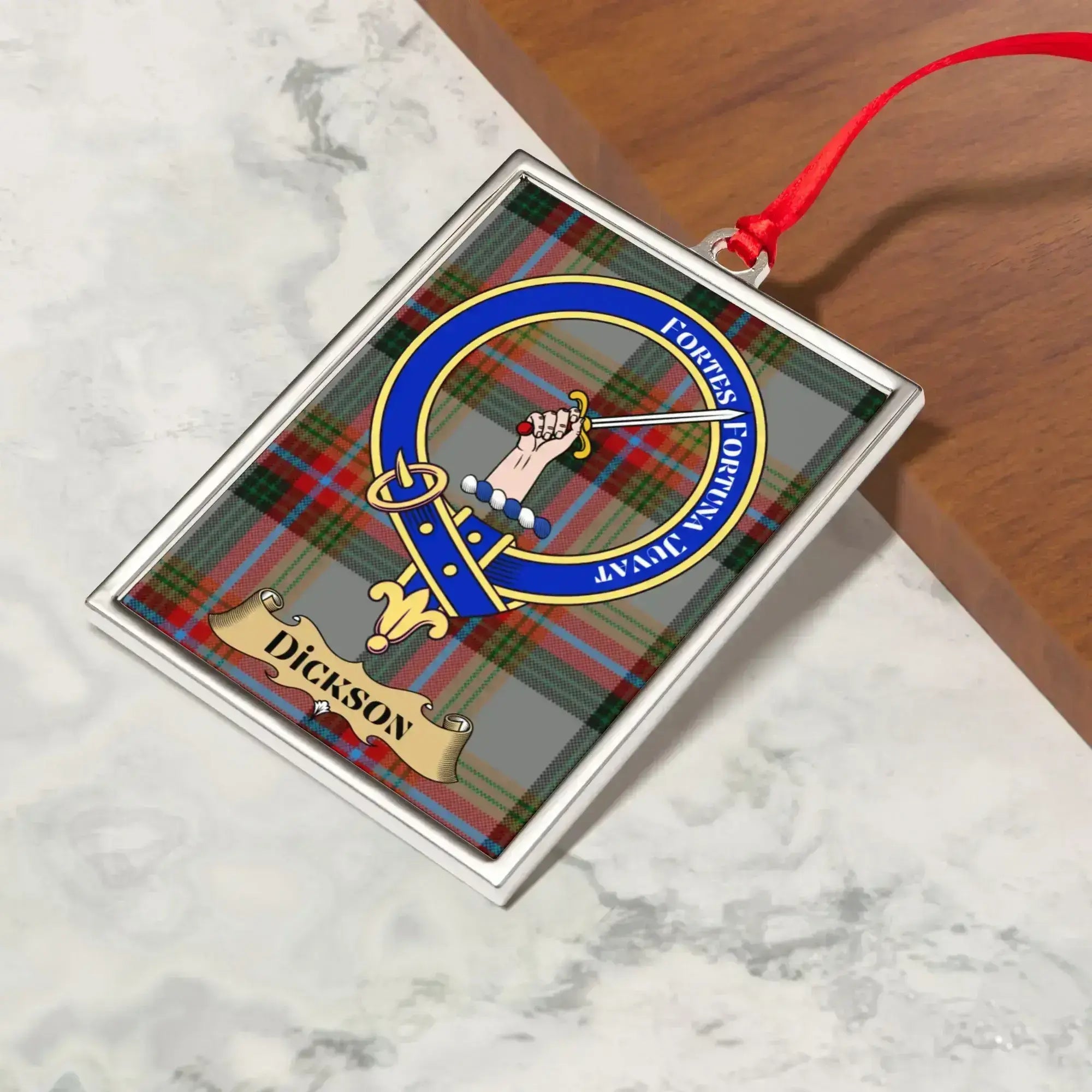 Dickson ornament hanging from a Christmas tree branch by its satin ribbon