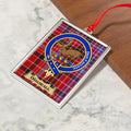 Dingwall ornament hanging from a Christmas tree branch by its satin ribbon