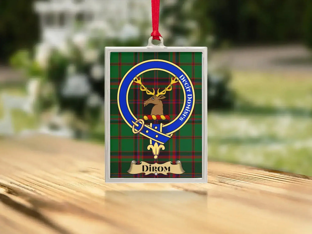 Close-up of the Dirom family crest on a polished silver-frame metal ornament