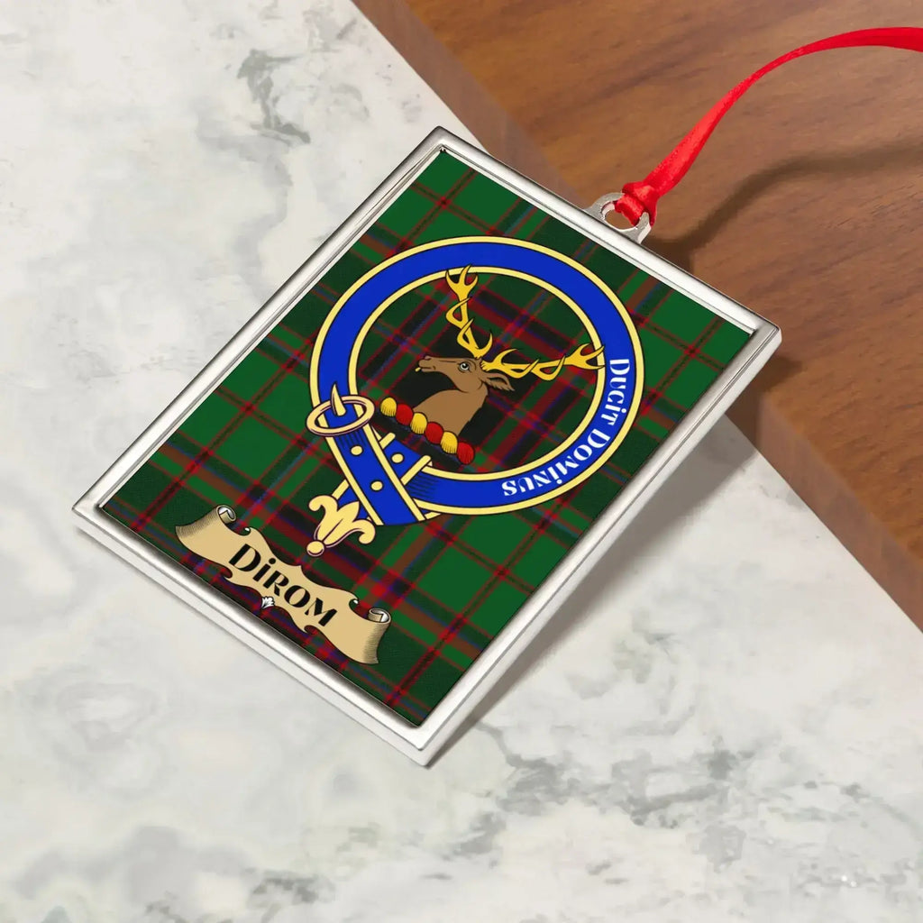 Dirom ornament hanging from a Christmas tree branch by its satin ribbon