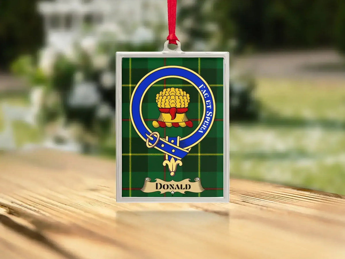 Close-up of the Donald family crest on a polished silver-frame metal ornament