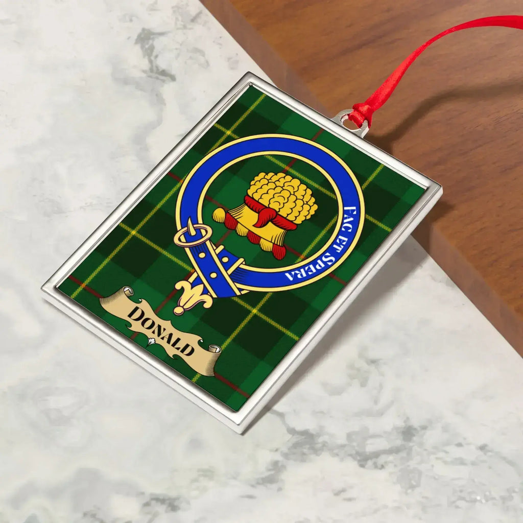 Donald ornament hanging from a Christmas tree branch by its satin ribbon