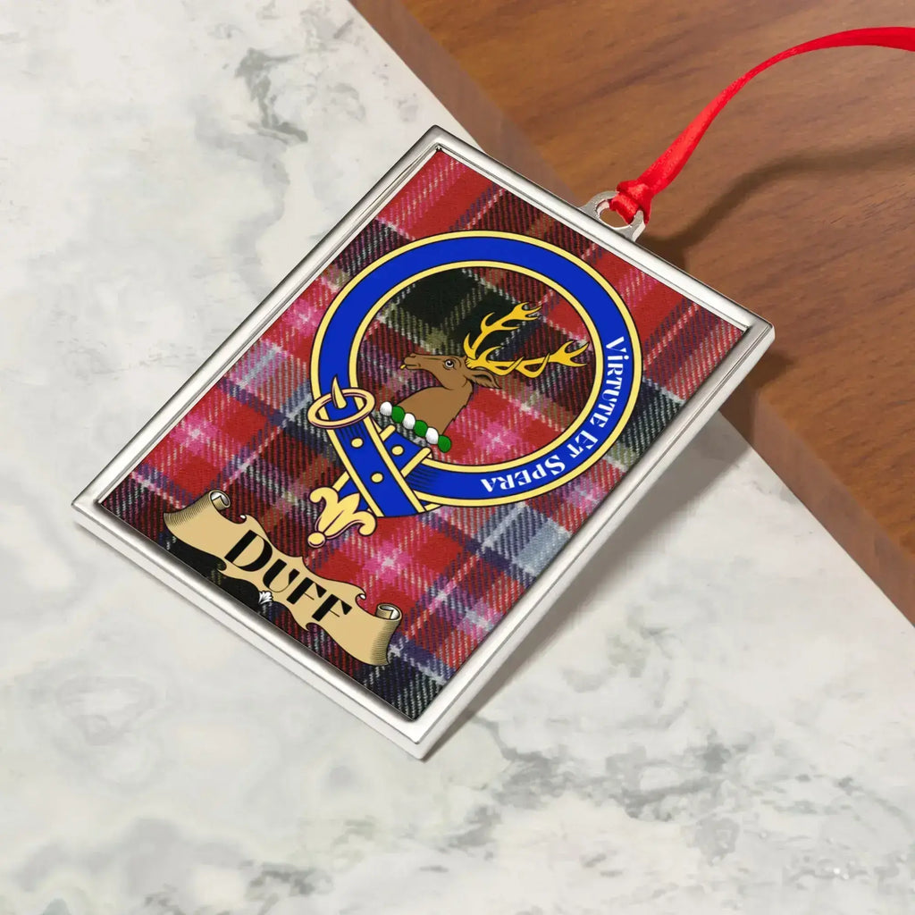 Duff ornament hanging from a Christmas tree branch by its satin ribbon