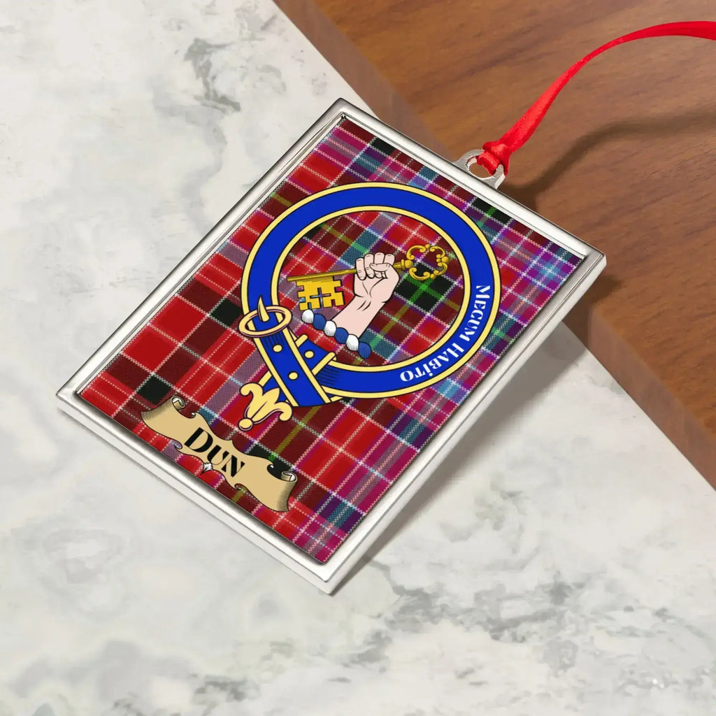 Dun ornament hanging from a Christmas tree branch by its satin ribbon