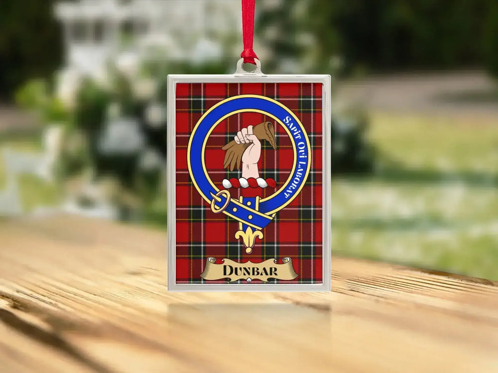 Close-up of the Dunbar family crest on a polished silver-frame metal ornament