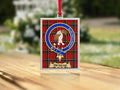 Close-up of the Dunbar family crest on a polished silver-frame metal ornament