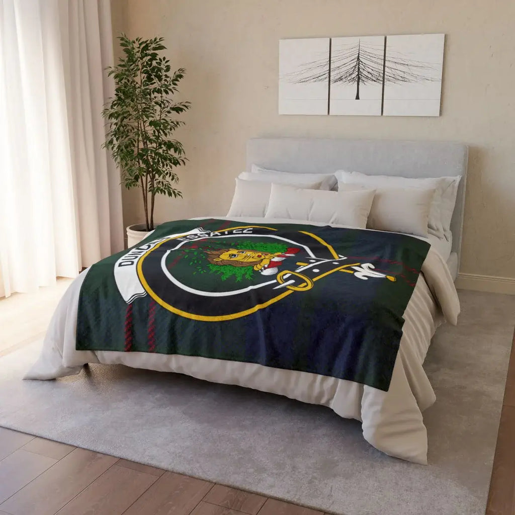 Dundas clan crest throw blanket draped over sofa — full-colour tartan print, white reverse