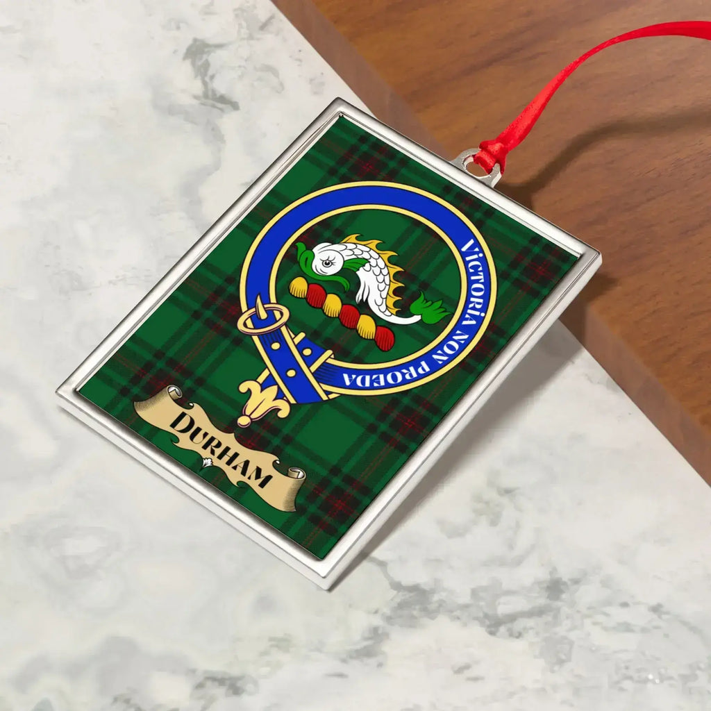 Durham ornament hanging from a Christmas tree branch by its satin ribbon