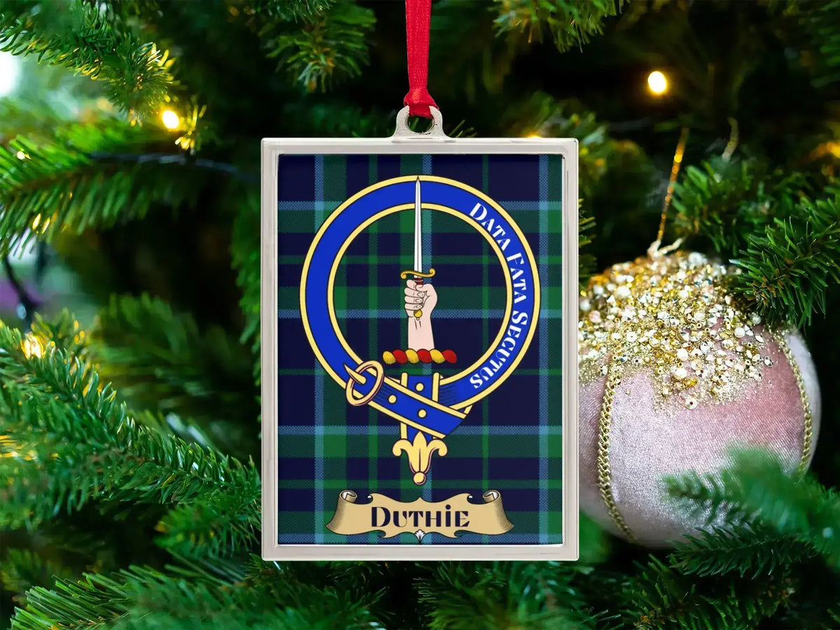 Duthie clan crest Christmas ornament in a silver frame on a tartan background