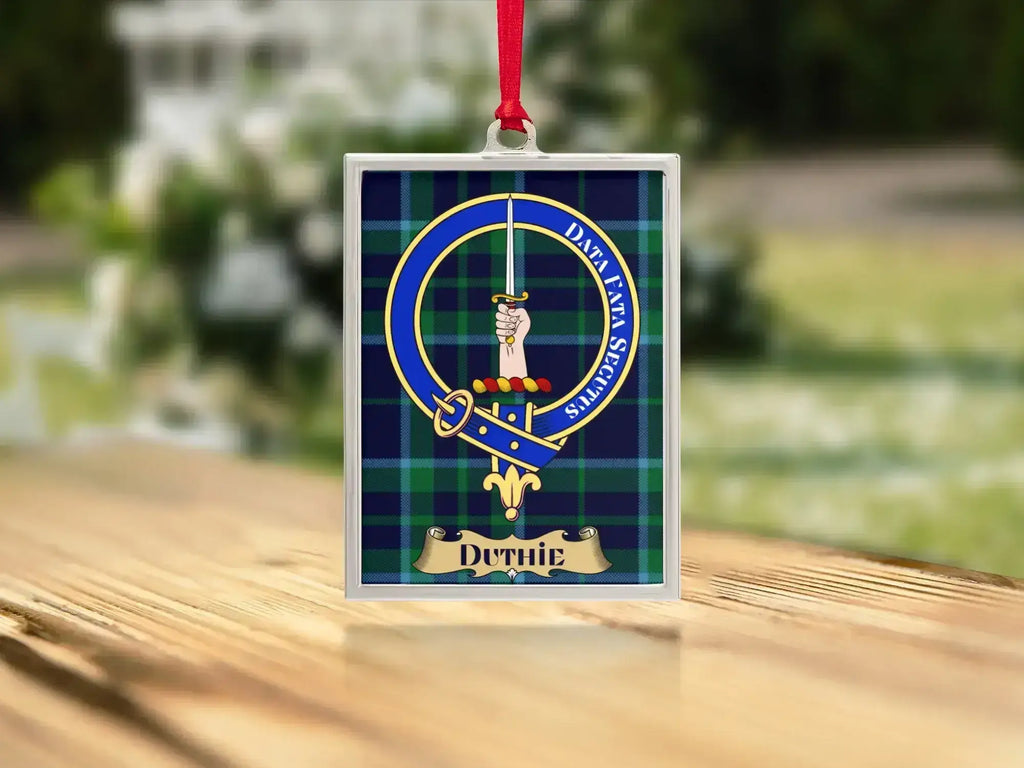 Close-up of the Duthie family crest on a polished silver-frame metal ornament