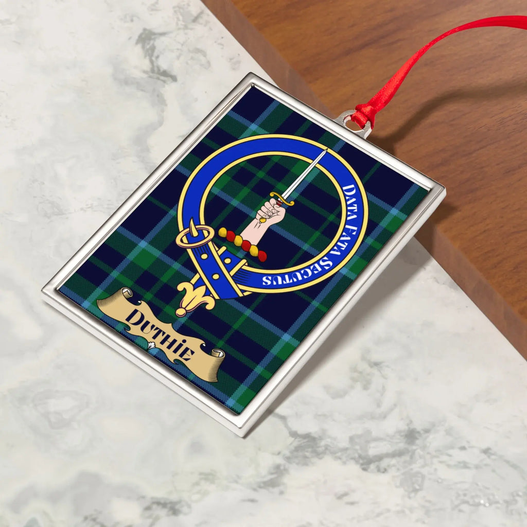 Duthie ornament hanging from a Christmas tree branch by its satin ribbon