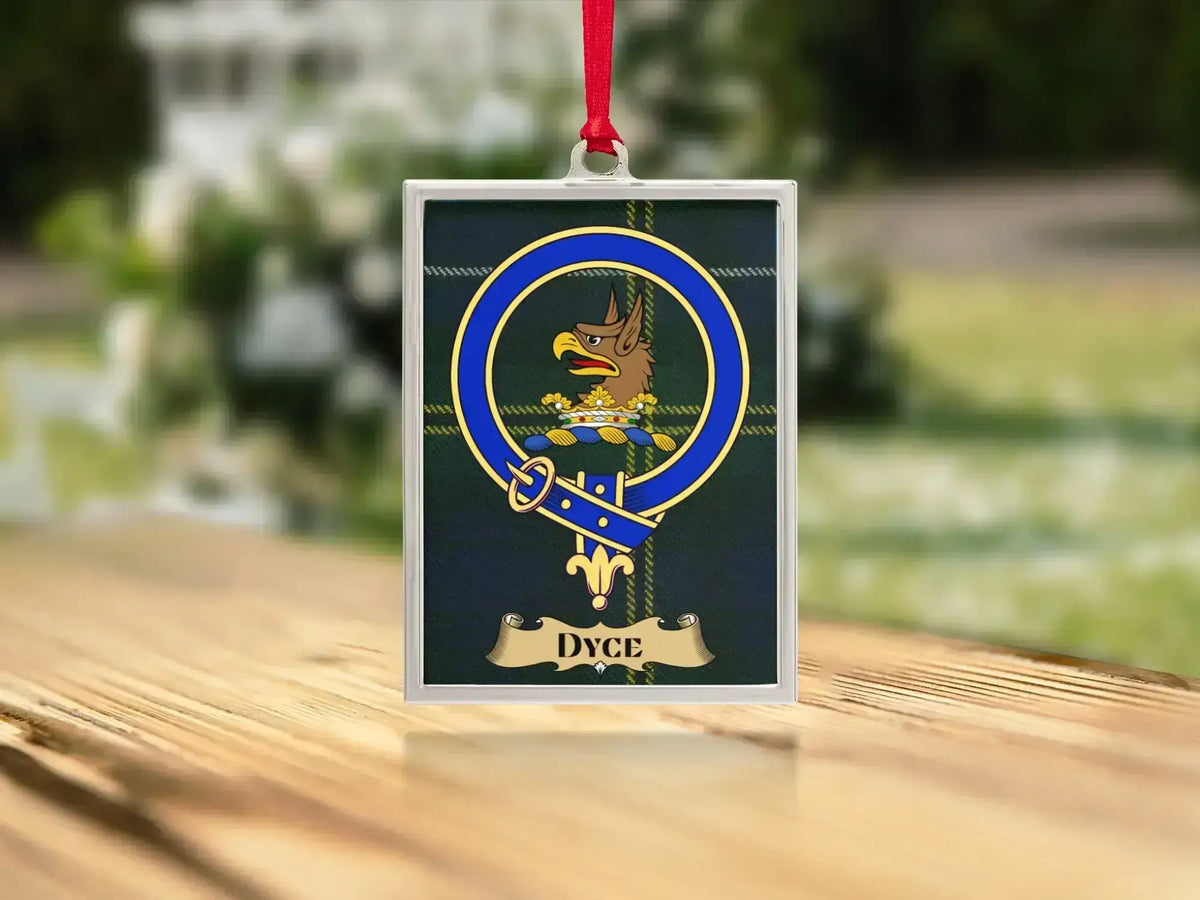 Close-up of the Dyce family crest on a polished silver-frame metal ornament