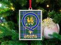Eckfoord clan crest Christmas ornament in a silver frame on a tartan background