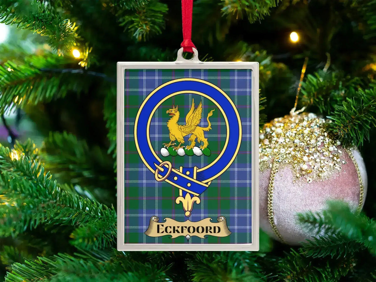 Eckfoord clan crest Christmas ornament in a silver frame on a tartan background