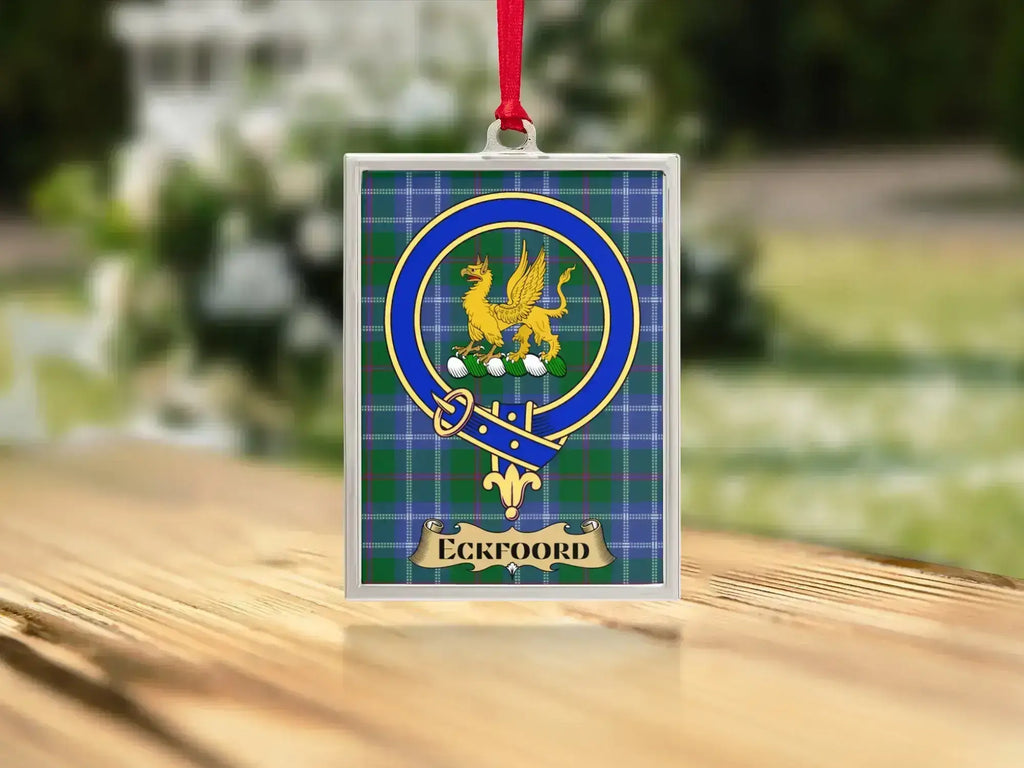 Close-up of the Eckfoord family crest on a polished silver-frame metal ornament