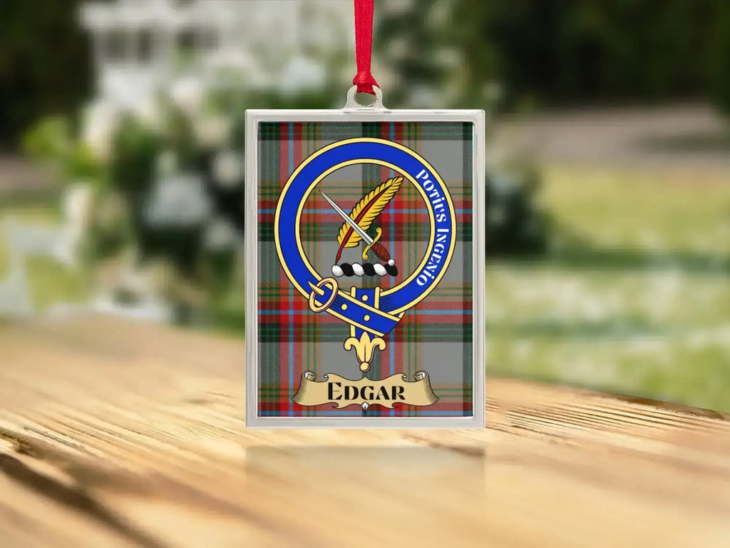 Close-up of the Edgar family crest on a polished silver-frame metal ornament