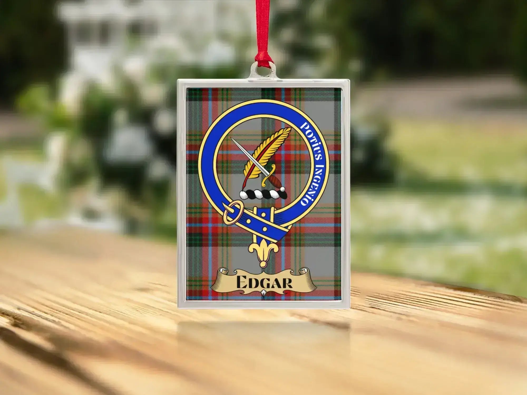 Close-up of the Edgar family crest on a polished silver-frame metal ornament